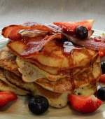 US Pancake Stack with crisp bacon, blueberries, strawberries & maple syrup